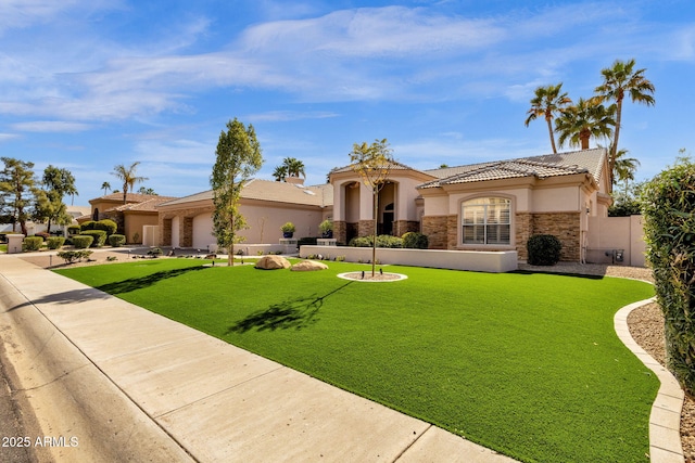 mediterranean / spanish-style home with stone siding, a front lawn, concrete driveway, and stucco siding