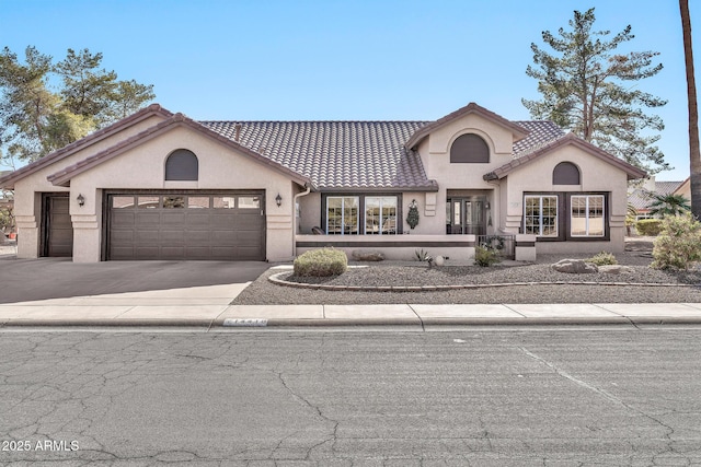 mediterranean / spanish-style home featuring a garage