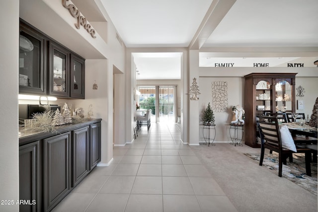 interior space featuring light tile patterned floors and dark brown cabinetry