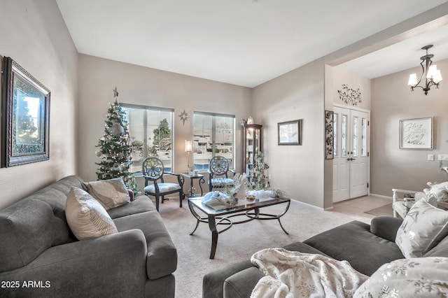 carpeted living room featuring an inviting chandelier