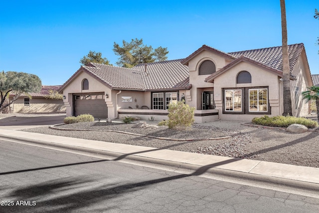 mediterranean / spanish-style house featuring a garage