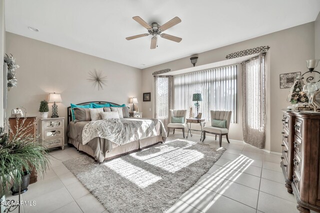 tiled bedroom featuring ceiling fan