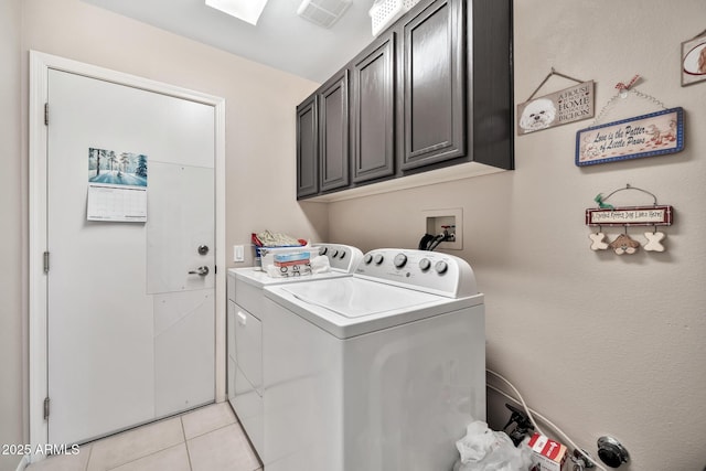 washroom featuring light tile patterned flooring, cabinets, and independent washer and dryer