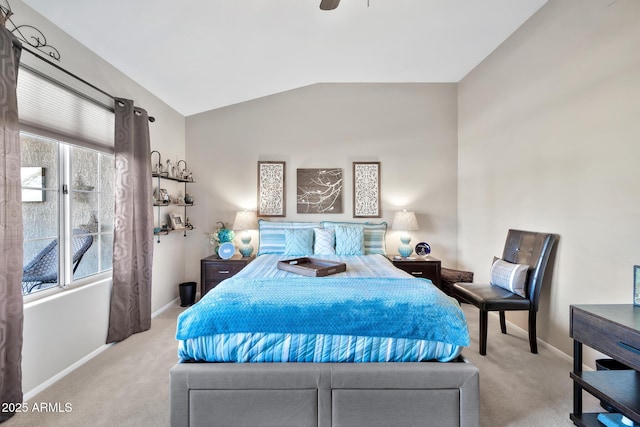 bedroom with ceiling fan, light colored carpet, and vaulted ceiling