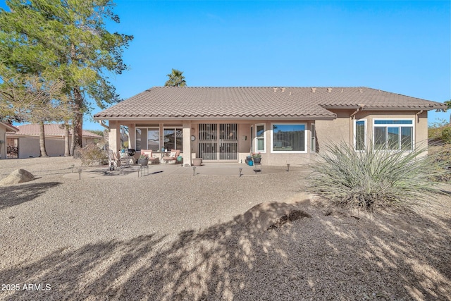 back of property featuring a patio area