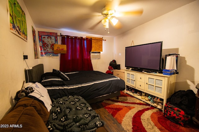 bedroom with cooling unit, ceiling fan, and hardwood / wood-style flooring