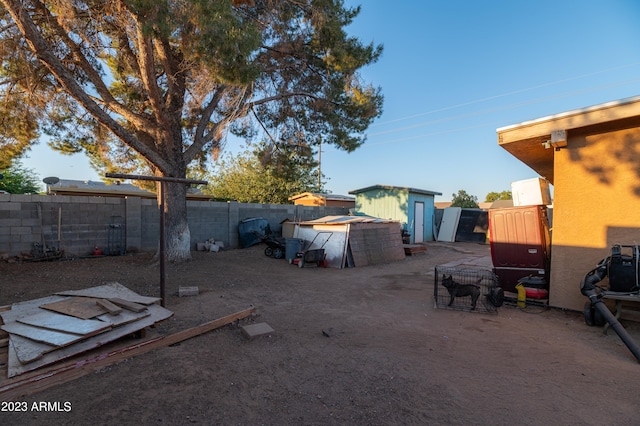 view of yard with a storage shed and a patio