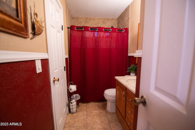 bathroom featuring tile patterned flooring, vanity, toilet, and a shower with curtain