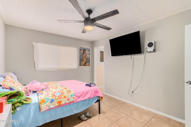 bedroom with ceiling fan and light tile patterned floors