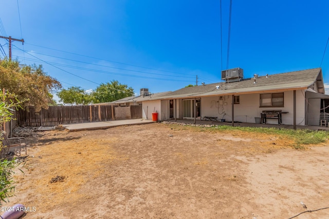 rear view of property featuring central air condition unit and a patio