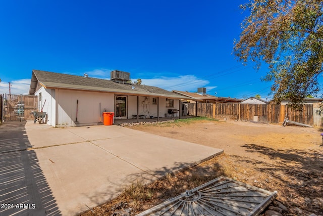 rear view of house featuring a patio and cooling unit