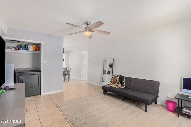 sitting room with light tile patterned flooring, ceiling fan, and washer / dryer