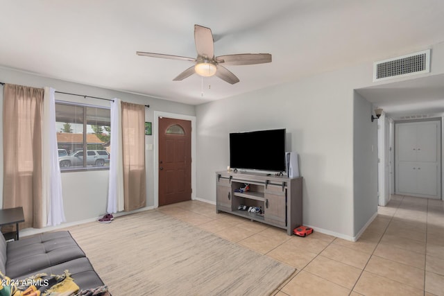 tiled living room with ceiling fan