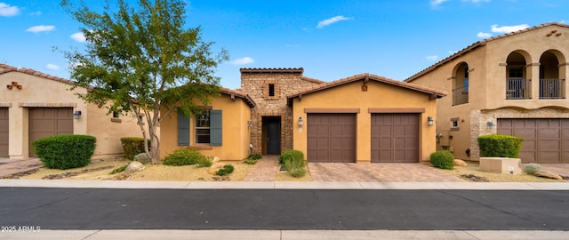 mediterranean / spanish house with a garage