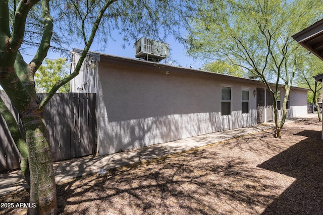 view of side of property with central air condition unit