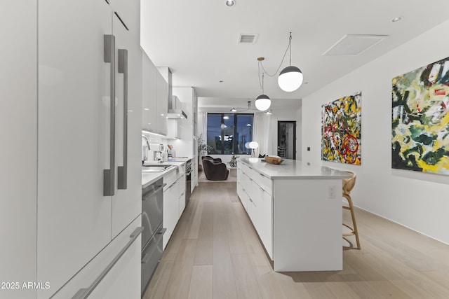 kitchen featuring white cabinetry, light countertops, modern cabinets, and a kitchen island
