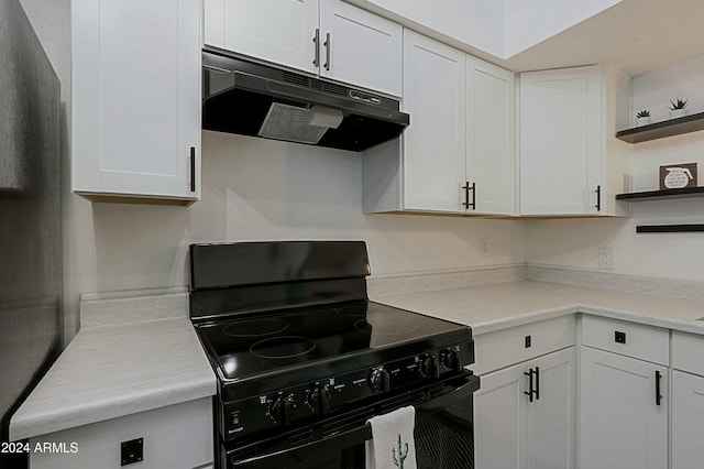 kitchen featuring black electric range oven and white cabinets