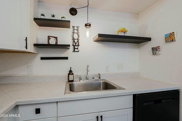 kitchen with white cabinetry, black dishwasher, sink, and decorative light fixtures