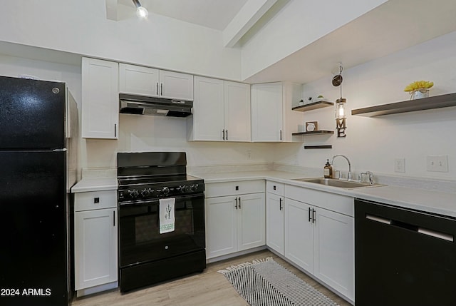 kitchen with white cabinetry, sink, light hardwood / wood-style floors, and black appliances