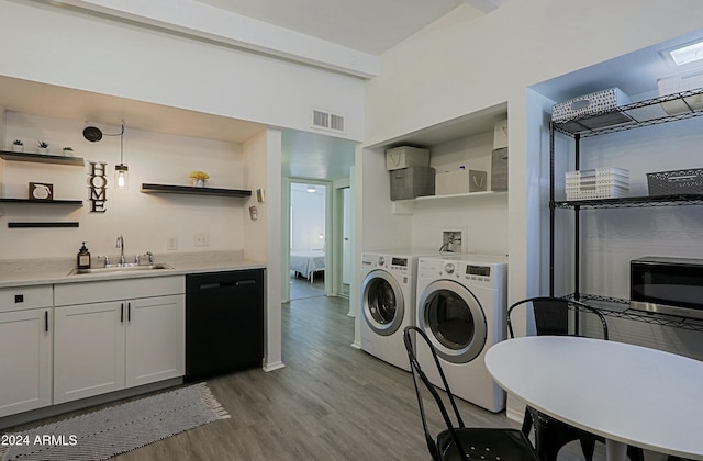 kitchen with sink, light hardwood / wood-style flooring, dishwasher, white cabinetry, and washer and dryer