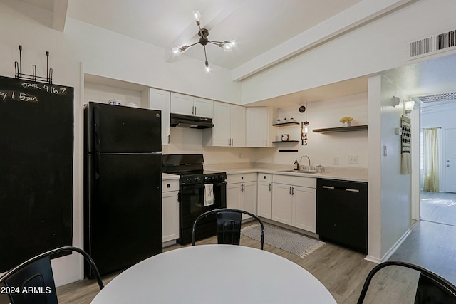 kitchen with lofted ceiling, sink, black appliances, light hardwood / wood-style floors, and white cabinets