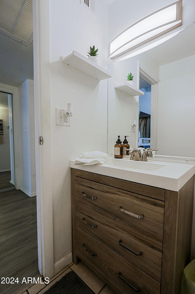 bathroom with vanity and wood-type flooring