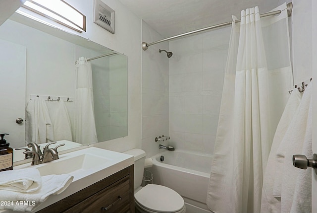 full bathroom featuring shower / tub combo with curtain, vanity, and toilet