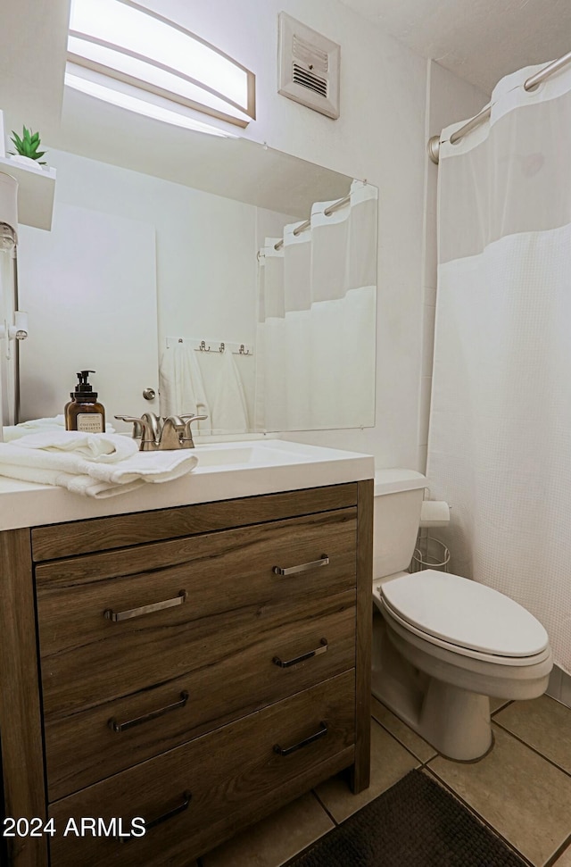 bathroom with tile patterned floors, toilet, and vanity