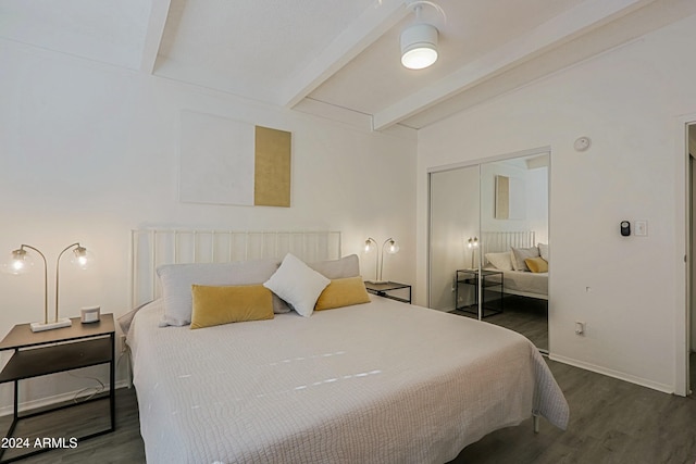 bedroom featuring vaulted ceiling with beams, dark hardwood / wood-style flooring, and a closet