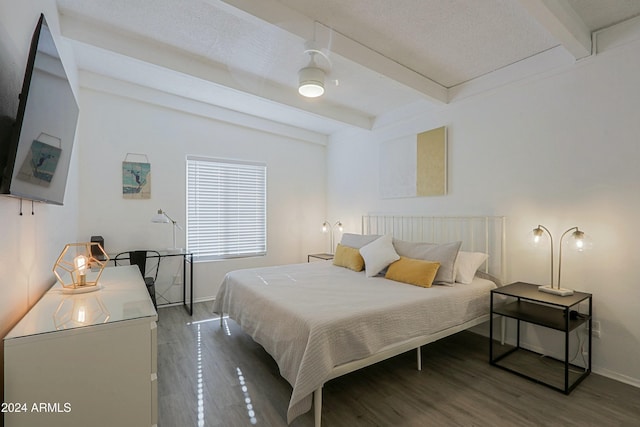 bedroom with beam ceiling and hardwood / wood-style flooring