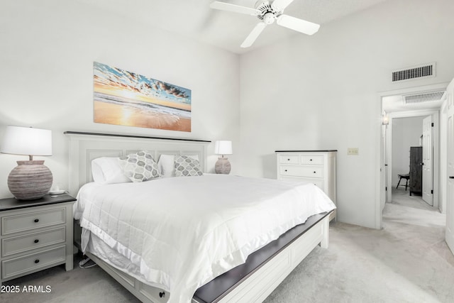 bedroom featuring light colored carpet and ceiling fan