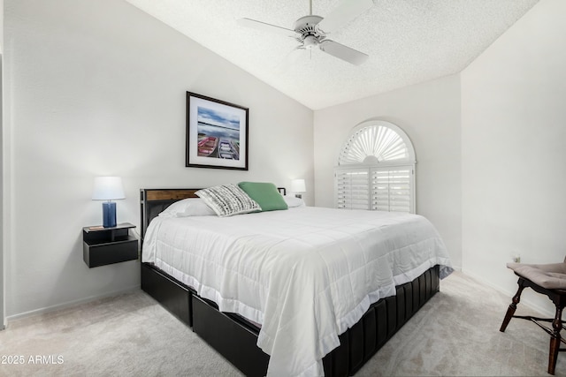 carpeted bedroom featuring lofted ceiling, ceiling fan, and a textured ceiling