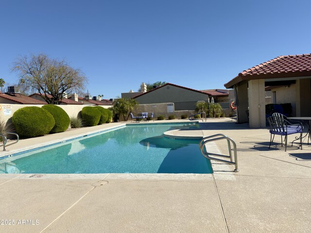 view of swimming pool featuring a patio area