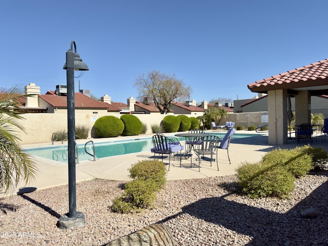 view of swimming pool featuring a patio area