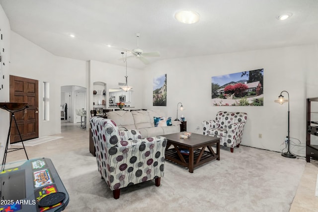 living room with high vaulted ceiling and ceiling fan