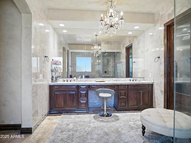 2822 E Constance Way, Phoenix, AZ 85042 - bathroom with a chandelier, tile walls, double vanity, and a shower stall