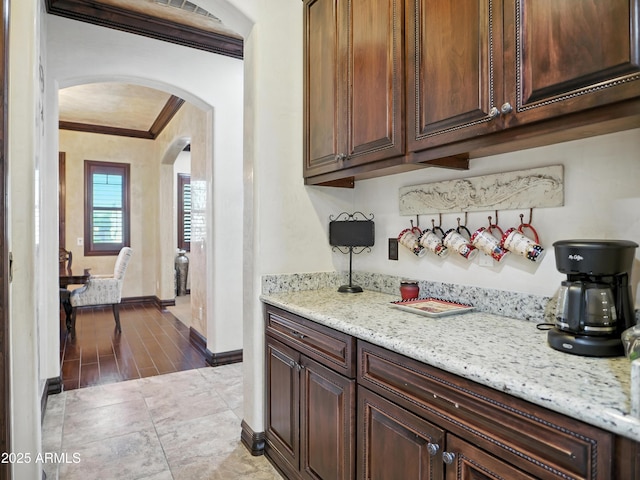 2822 E Constance Way, Phoenix, AZ 85042 - kitchen with ornamental molding, arched walkways, and light stone counters
