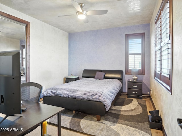 2822 E Constance Way, Phoenix, AZ 85042 - bedroom with a textured wall, carpet, and a ceiling fan