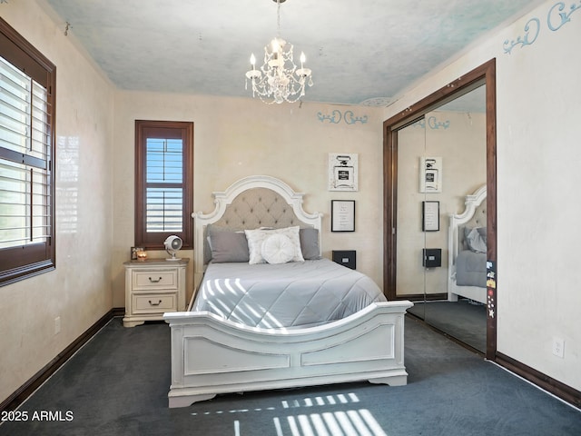 2822 E Constance Way, Phoenix, AZ 85042 - bedroom with dark colored carpet, a chandelier, and a closet
