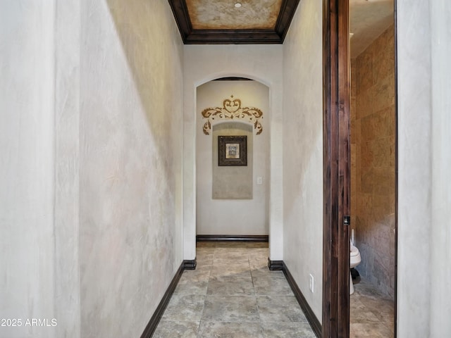 2822 E Constance Way, Phoenix, AZ 85042 - hallway with crown molding, light stone finish flooring, and arched walkways