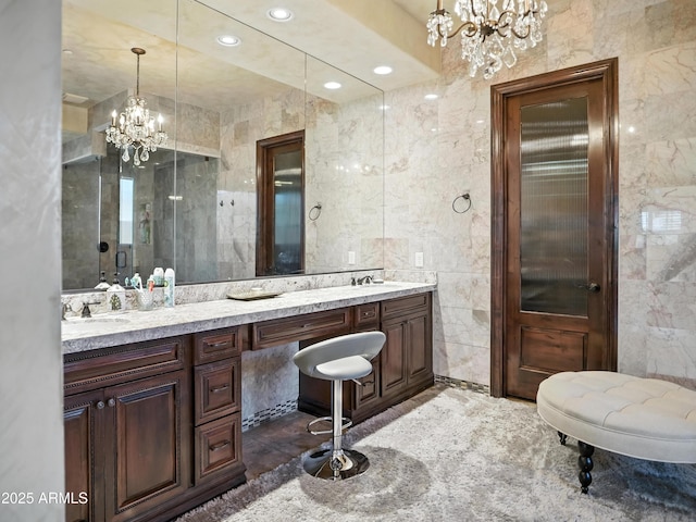 2822 E Constance Way, Phoenix, AZ 85042 - full bath with a chandelier, tile walls, double vanity, an enclosed shower, and recessed lighting