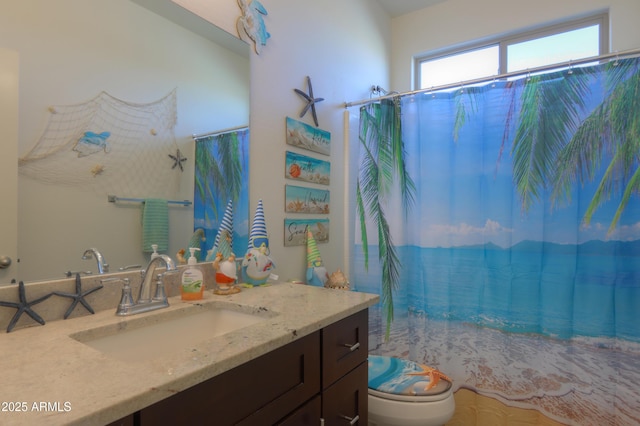 bathroom featuring toilet and vanity