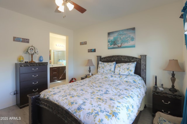 bedroom with light wood-type flooring and connected bathroom