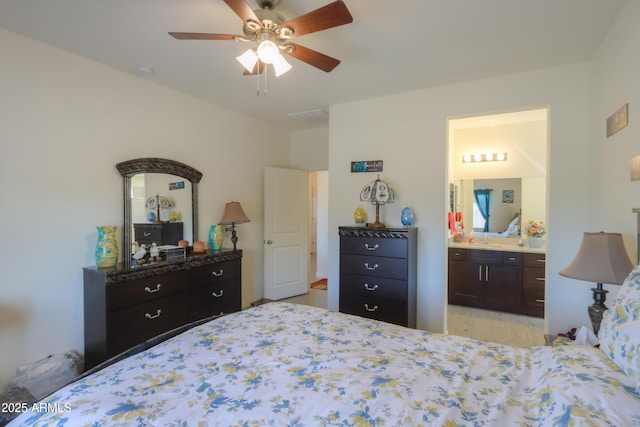 bedroom featuring a ceiling fan and ensuite bath