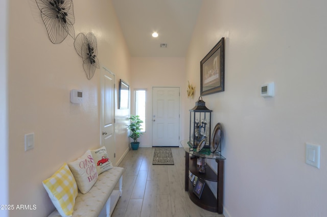 doorway with light wood-style floors and baseboards