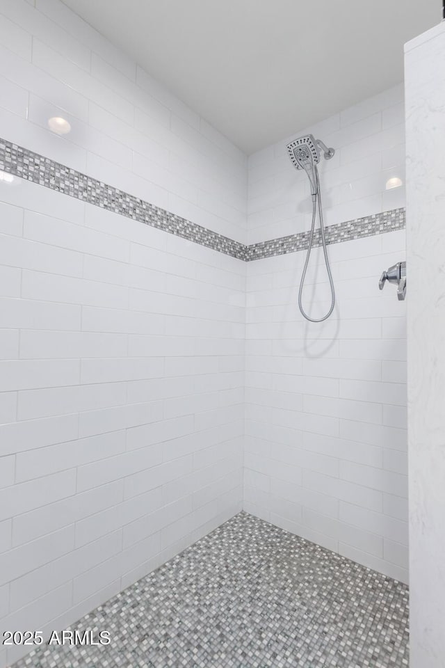 bathroom with tiled shower