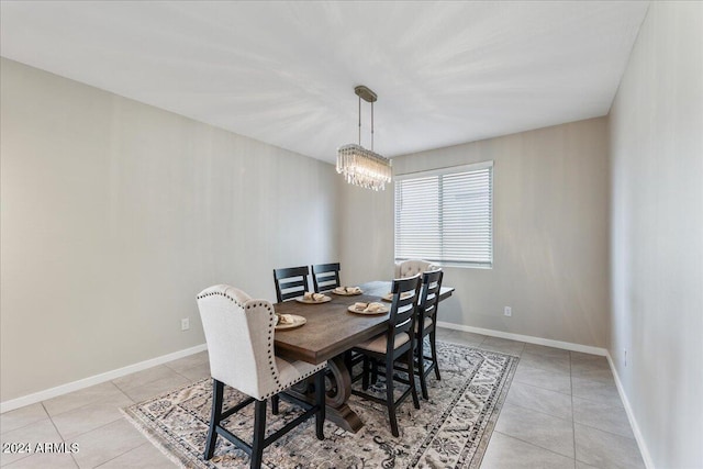 dining room featuring light tile patterned floors and a chandelier