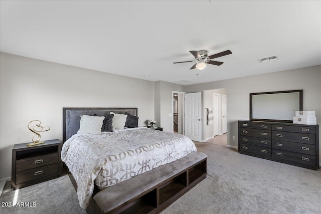 bedroom featuring ceiling fan and light carpet