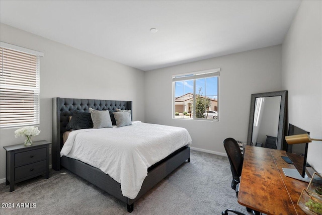 bedroom featuring light colored carpet and multiple windows