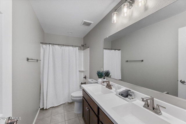 bathroom featuring tile patterned flooring, vanity, curtained shower, and toilet